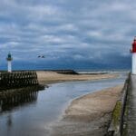 Molo z latarniami w Trouville we Francji pod zachmurzonym niebem